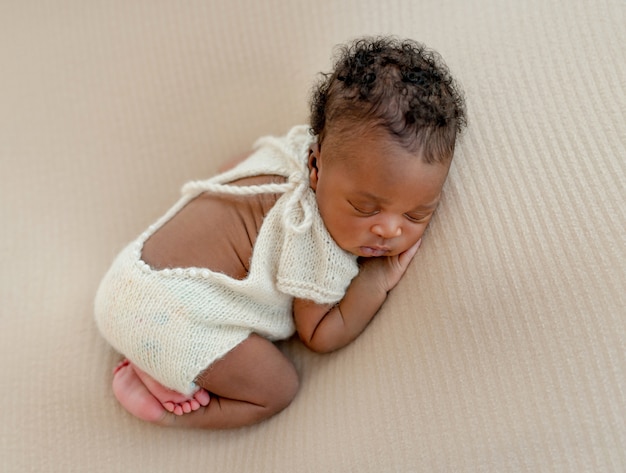 Newborn sleeps with crossed legs