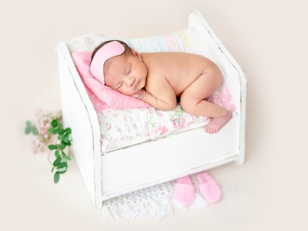 Newborn on tiny bed