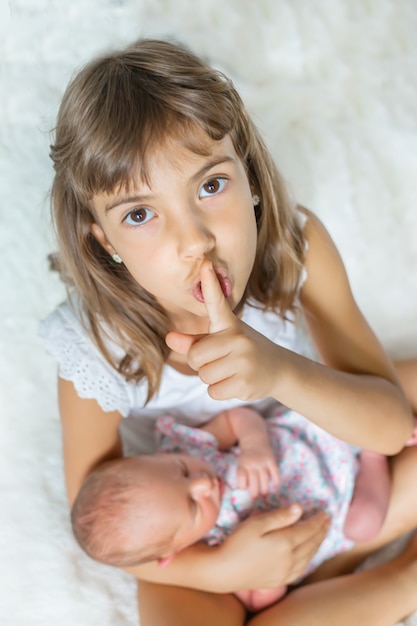 Newborn toddler with older sister