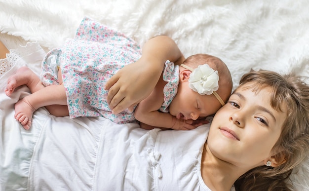 Newborn toddler with older sister