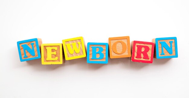 Newborn word made from colourful wooden baby development blocks