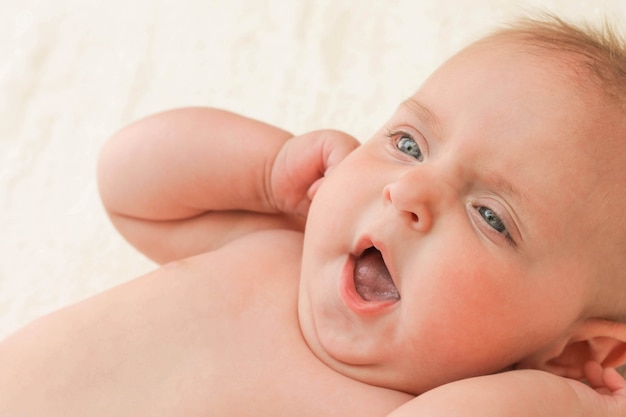 Newborn yawns. Face closeup 