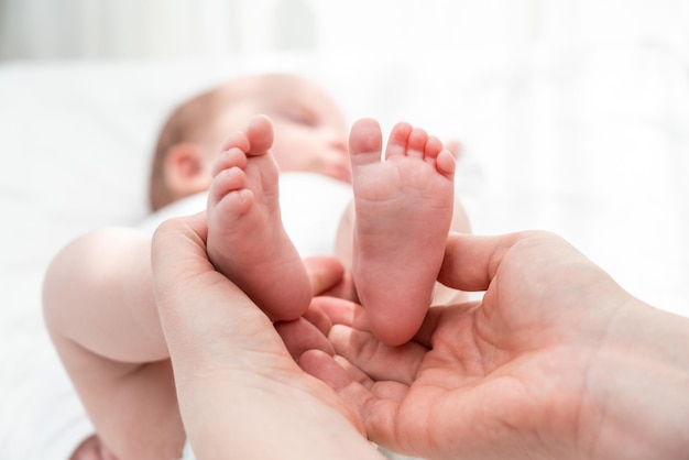 Newborns tiny feet held with care concept of a mothers protective embrace