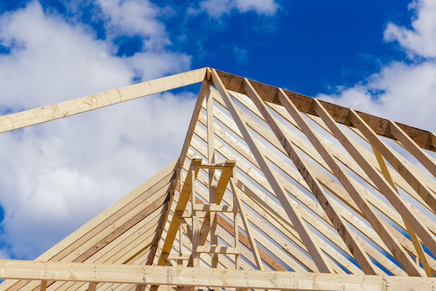 newly built wooden skeleton frame of house roof section view in construction site