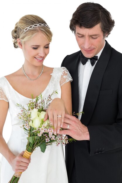 Newly wed couple looking at wedding rings