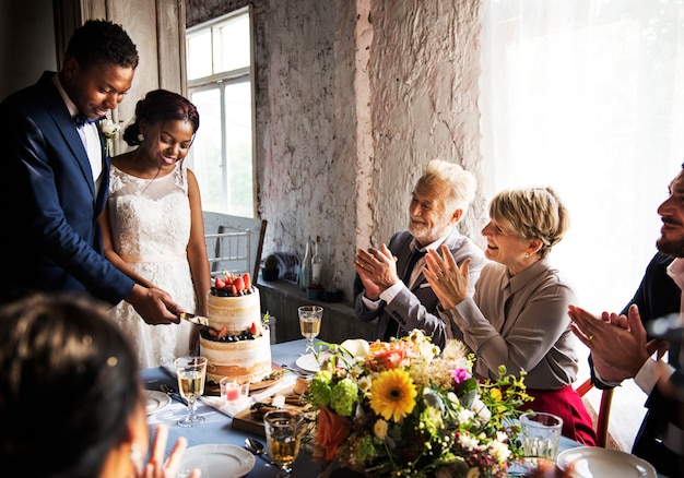 Newlywed Couple Hands Cutting Cake Together