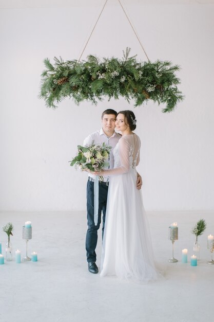 Newlywed couple happy together at white decorated room