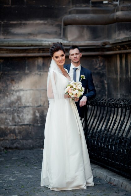 Newlywed couple posing outdoor