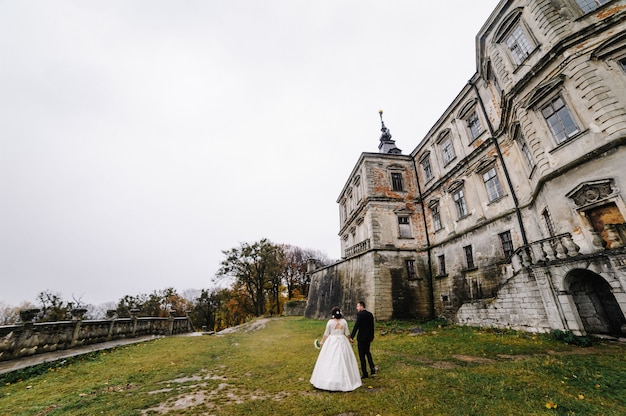 Newlyweds are walking their backs