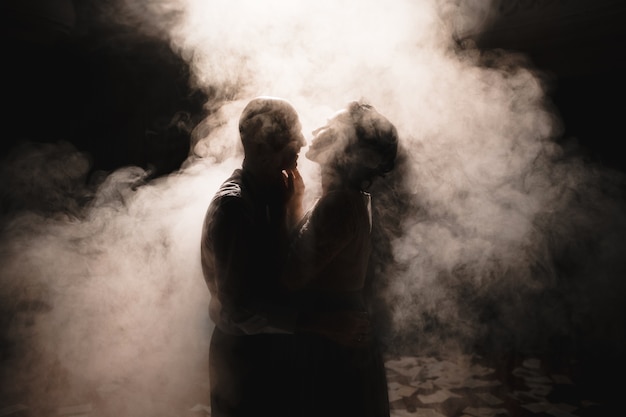 Newlyweds dancing among smoke