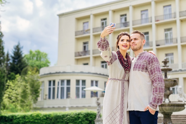 Newlyweds in embroidered clothes are standing