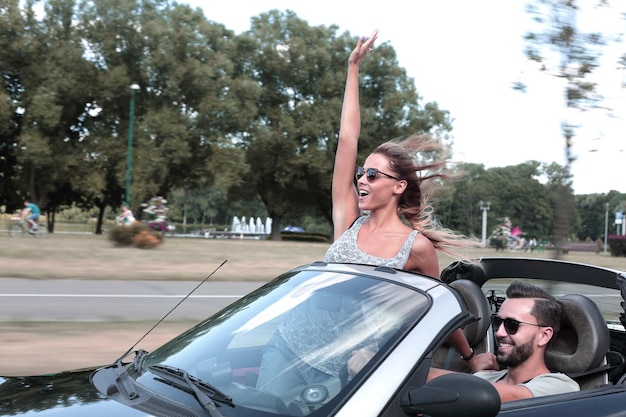 Newlyweds enjoying a trip in a convertible