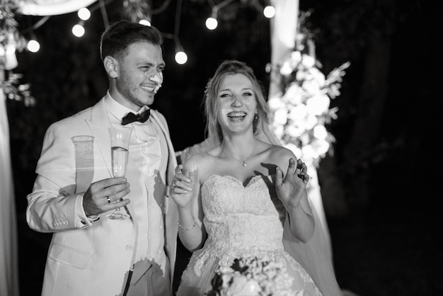 Newlyweds happily cut laugh and taste the wedding cake