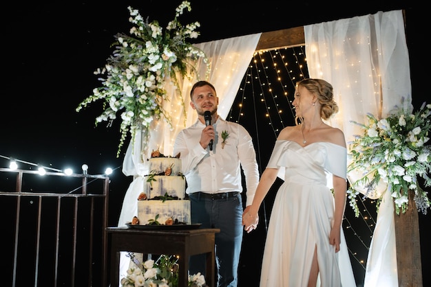 Newlyweds happily cut laugh and taste the wedding cake