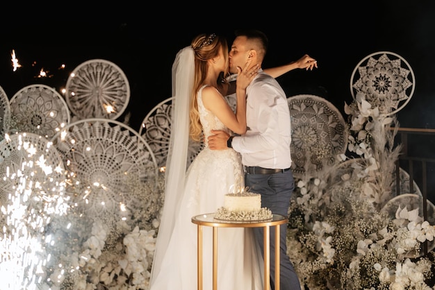 Newlyweds happily cut laugh and taste the wedding cake