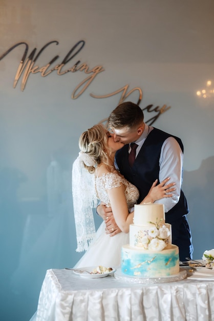 Newlyweds happily cut laugh and taste the wedding cake