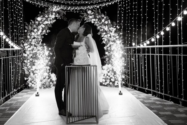 Newlyweds happily cut laugh and taste the wedding cake