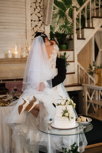 Newlyweds happily cut laugh and taste the wedding cake