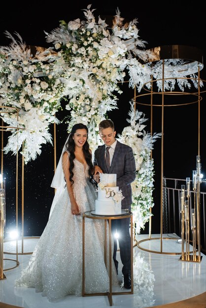 Newlyweds happily cut laugh and taste the wedding cake