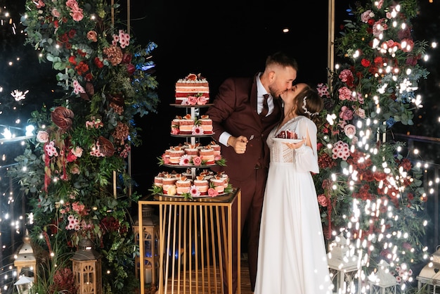 Newlyweds happily cut laugh and taste the wedding cake