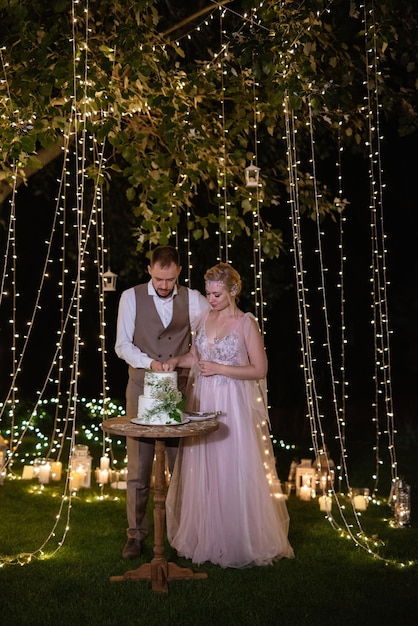 Newlyweds happily cut laugh and taste the wedding cake