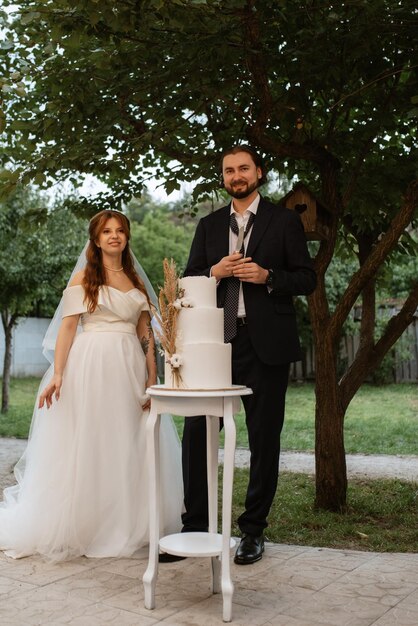 Newlyweds happily cut and taste the wedding cake