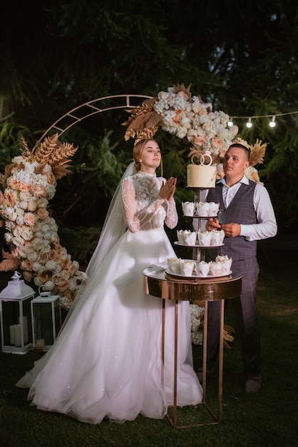 Newlyweds happily cut and taste the wedding cake