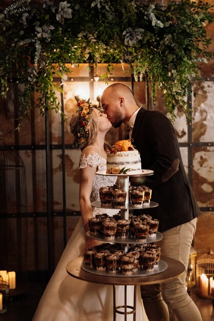 Newlyweds happily cut and taste the wedding cake