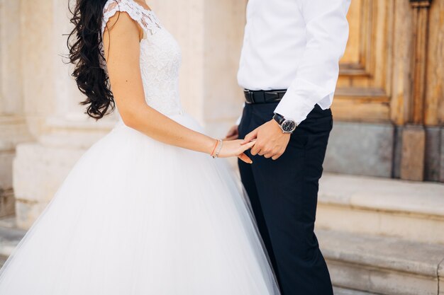 The newlyweds hold hands couple holding hands wedding in monte