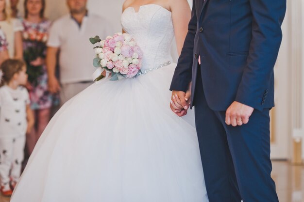 Newlyweds hold hands tightly at the wedding ceremony 2447