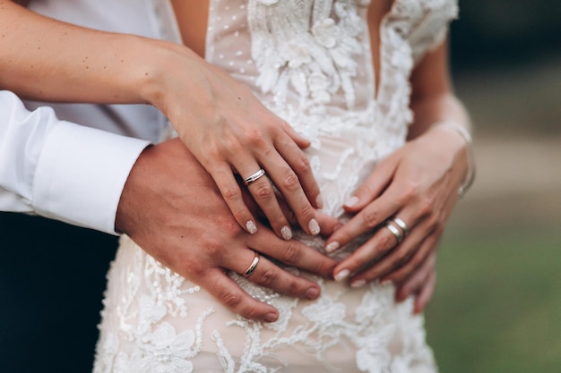 Newlyweds husband and wife hugging wedding rings closeup faceless