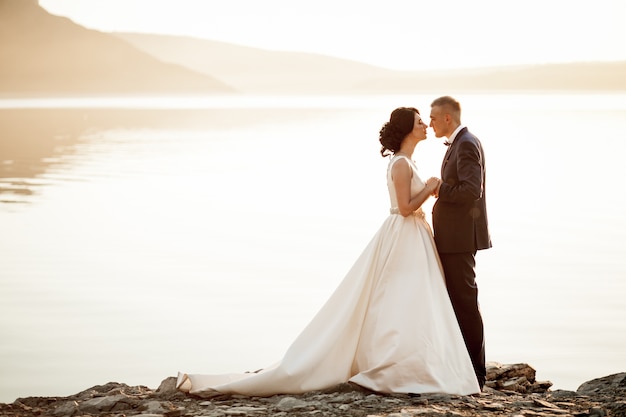 Newlyweds looking at each other in the lake