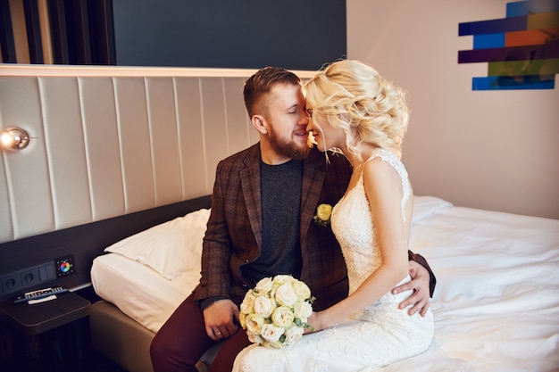 Newlyweds in the morning in the hotel room 