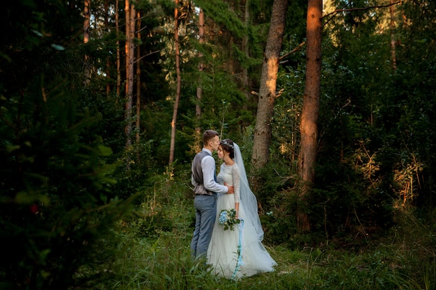 Newlyweds posing in the forest