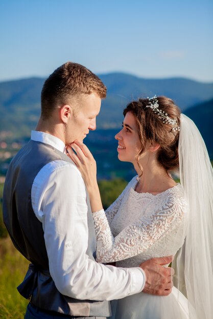 Newlyweds posing on a meadow