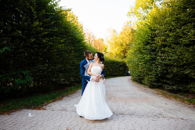 Newlyweds posing in a park