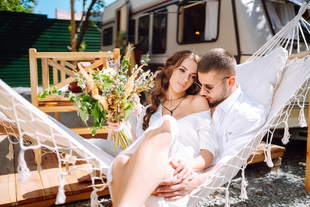 Newlyweds tenderly hug kiss and enjoy each other in rv camping in a trailer wedding love