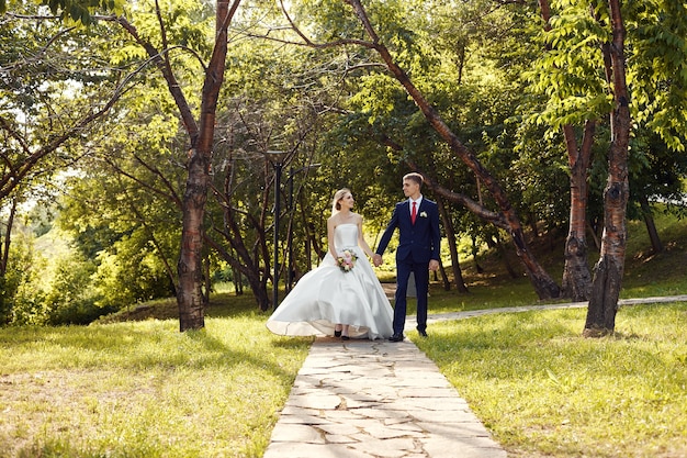 Newlyweds walk in nature in the Park after the wedding ceremony