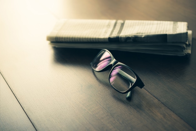 Newspaper and reading glasses on business desk business newspaper  .