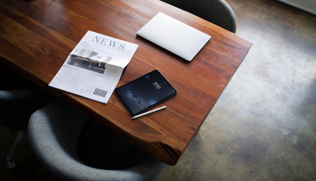 Newspaper on a table with a digital tablet