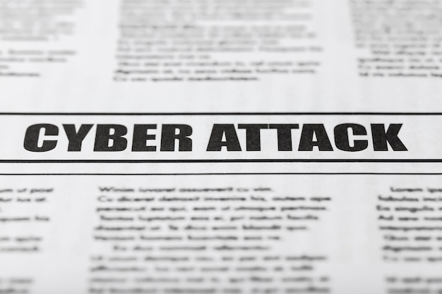 Photo newspaper with text cyber attack, close up