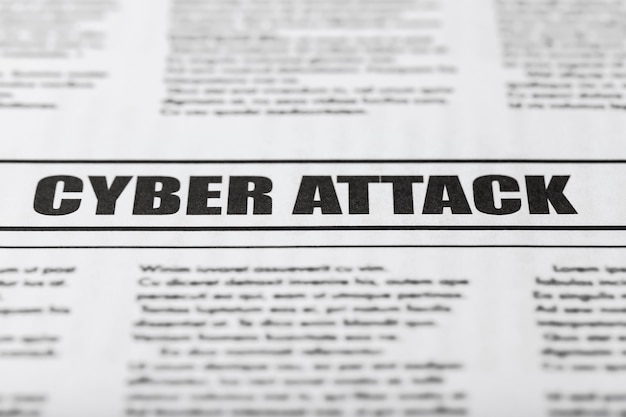 Newspaper with text CYBER ATTACK, close up