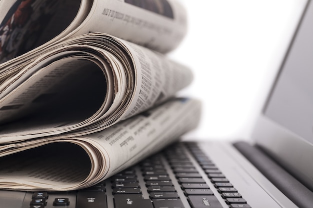 Newspapers on the laptop. Online news. Isolated