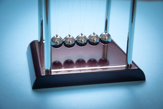 Newton's cradle balls on the blue background