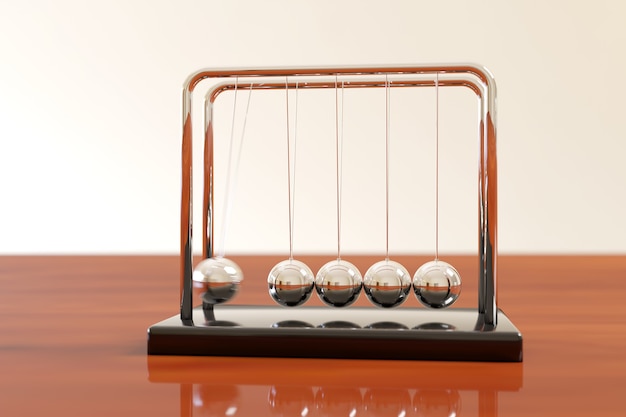 Photo newton's cradle swinging on a wooden table