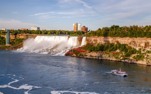 Niagara Falls Cruise boat with tourists moves along the river