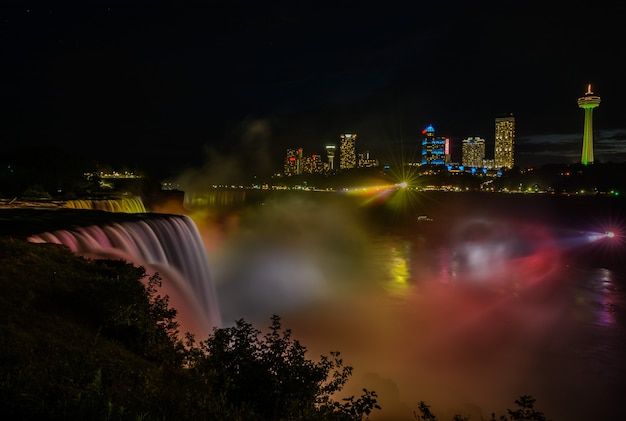 Niagara Falls lit at night by colorful lights