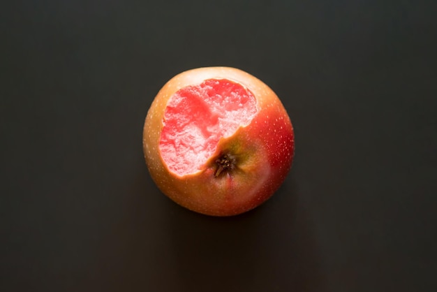 Nibbled an apple with red flesh inside isolated on a black background Top view Above Nutrient Healthful Body Color