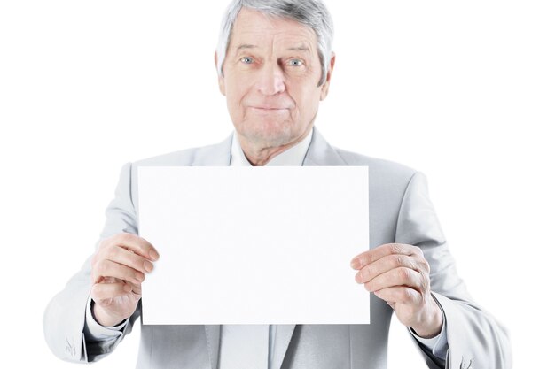 Nice businessman at the age oft holding a big white poster isolated on a white background