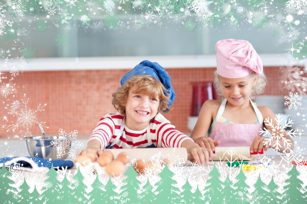 Nice children baking in a kitchen against snow